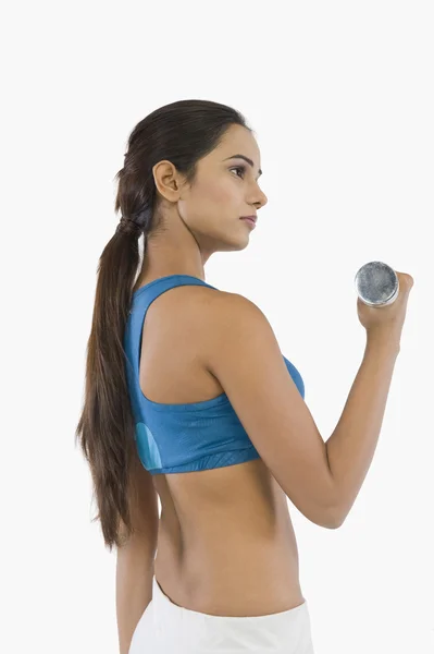 Woman exercising with a dumbbell — Stock Photo, Image