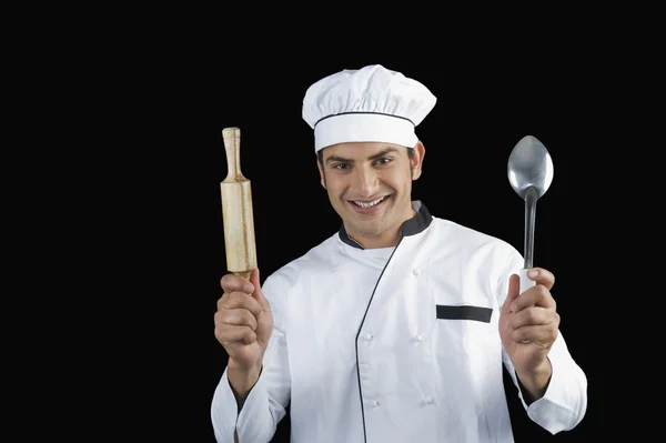 Chef holding a rolling pin and a ladle — Stock Photo, Image
