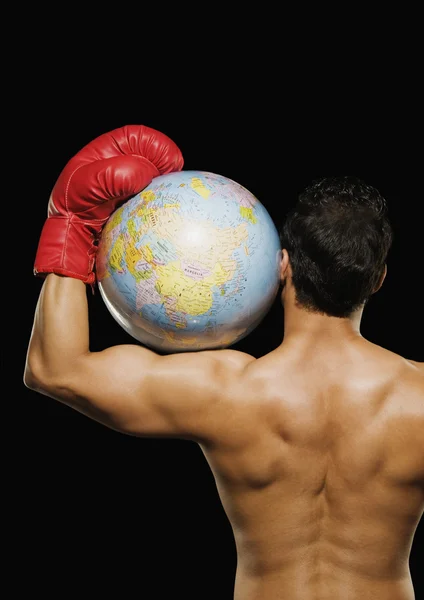 Male boxer holding a globe over his head — Stock Photo, Image