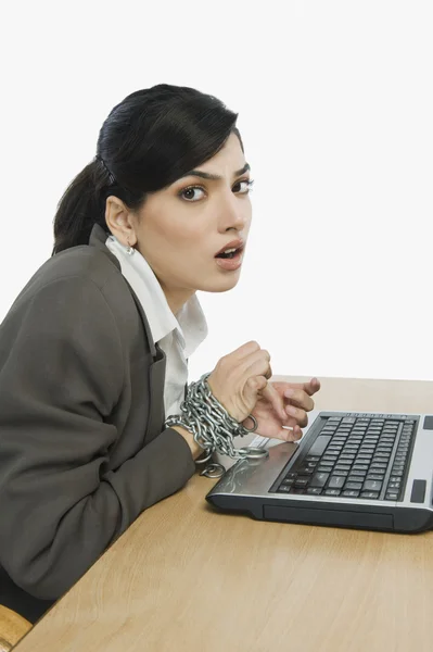 Businesswoman chained to her desk — Stock Photo, Image