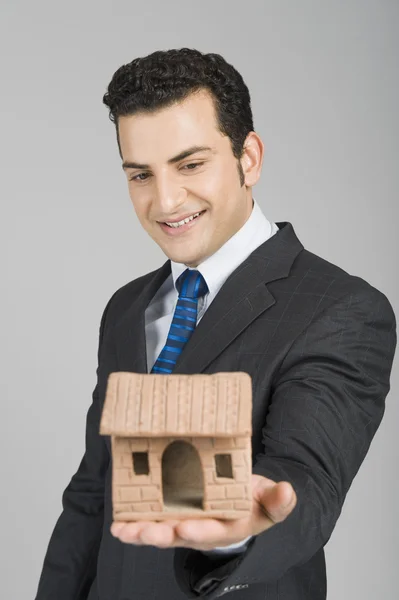 Zakenman houden een model huis — Stockfoto