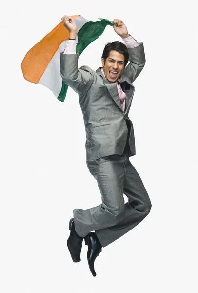 Businessman jumping with holding Indian flag — Stock Photo, Image