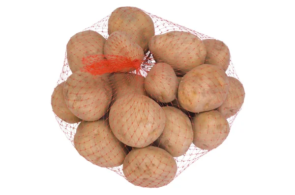 Close-up van ruwe aardappelen in een netto zak — Stockfoto