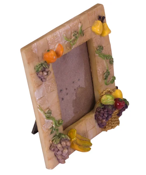 Close-up of a picture frame decorated with artificial fruits — Stock Photo, Image