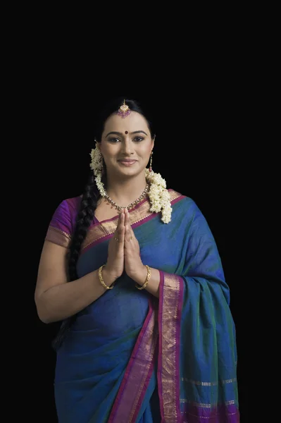 Woman making a greeting gesture — Stock Photo, Image