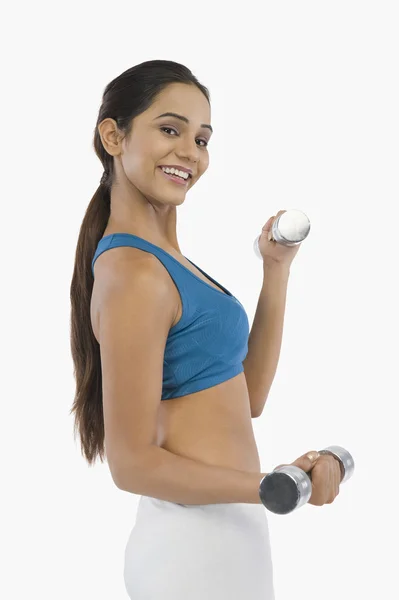 Woman exercising with dumbbells — Stock Photo, Image