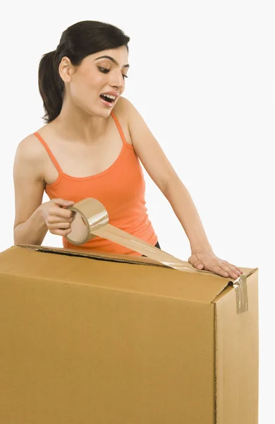 Woman packing cardboard by packing tape — Stock Photo, Image