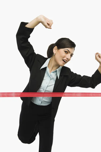 Businesswoman crossing the finishing line — Stock Photo, Image