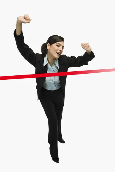 Businesswoman crossing the finishing line — Stock Photo, Image