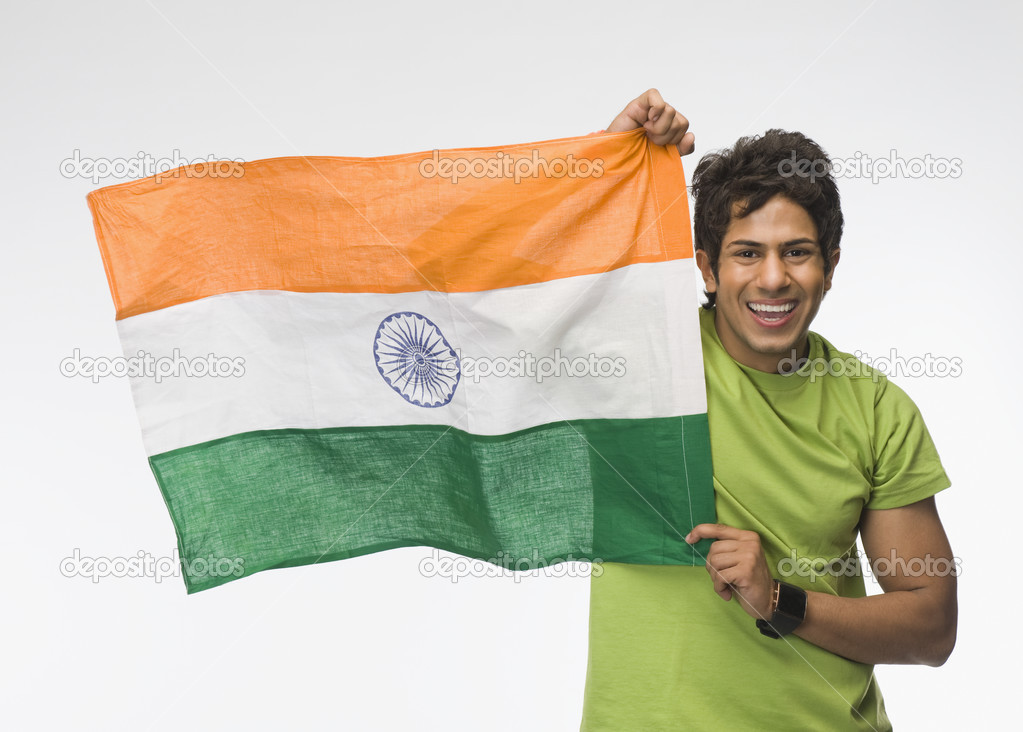 Man holding aloft an Indian flag