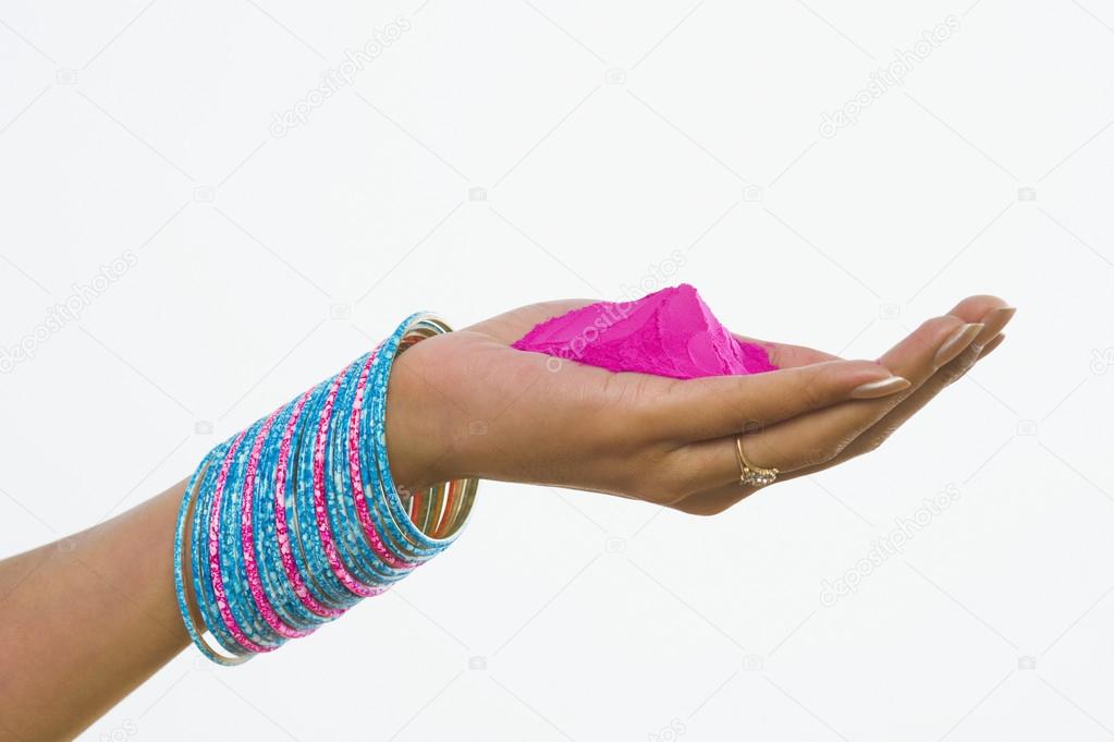 Hand holding Holi colors