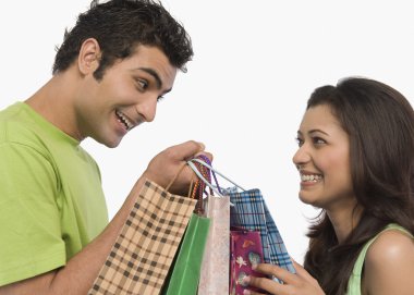 Couple carrying shopping bags clipart