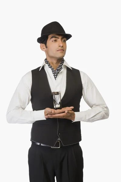 Businessman holding an hourglass — Stock Photo, Image