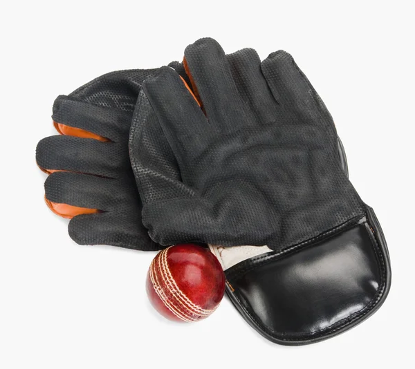 Cricket ball with a pair of wicket keeping gloves — Stock Photo, Image