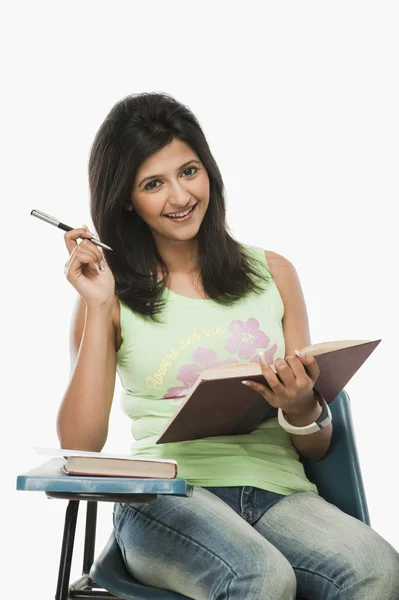 Student smiling in a classroom — Stock Photo, Image