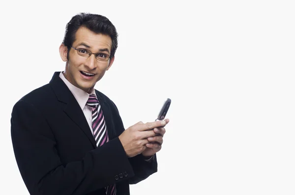 Businessman looking surprised while text messaging — Stock Photo, Image