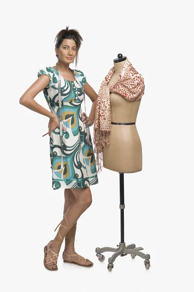 Fashion designer trying a dress on a mannequin — Stock Photo, Image