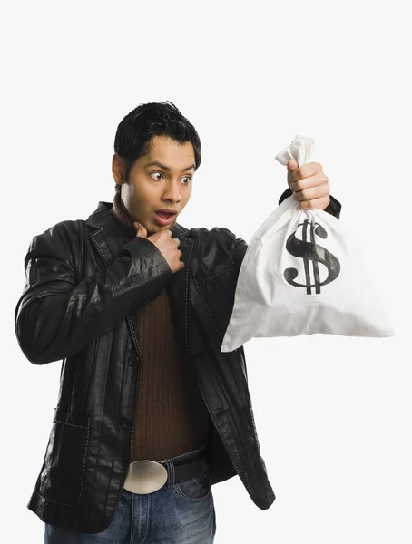 Man holding a money bag — Stock Photo, Image