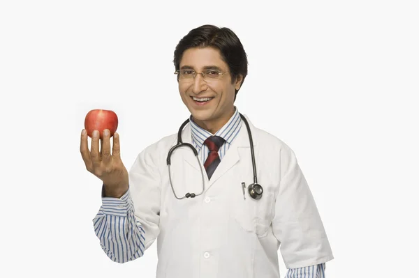 Doctor holding an apple — Stock Photo, Image