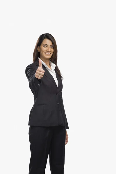 Businesswoman gesturing thumbs up sign — Stock Photo, Image