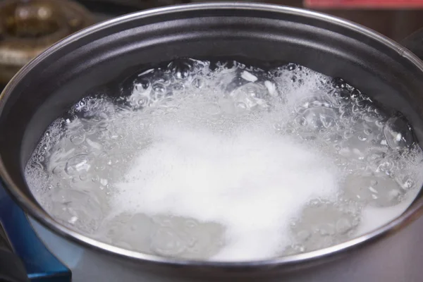 Rice boiling in a pan — Stock Photo, Image