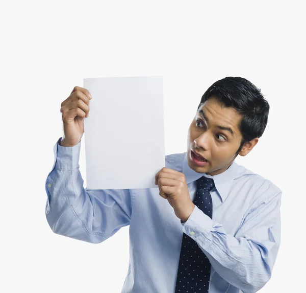 Businessman showing a sheet of blank paper — Stock Photo, Image