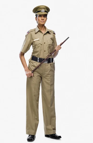 Female police officer holding a stick — Stock Photo, Image