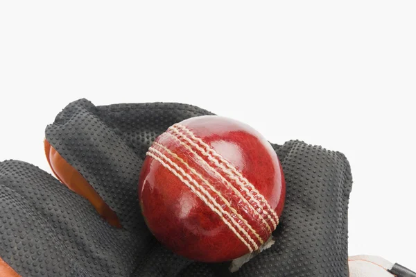 Cricket ball on a wicket keeping glove — Stock Photo, Image