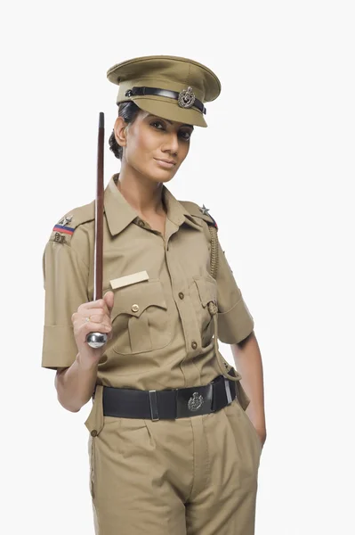 Female police officer holding a stick — Stock Photo, Image