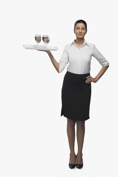 Air hostess carrying a tray of wine glasses — Stock Photo, Image