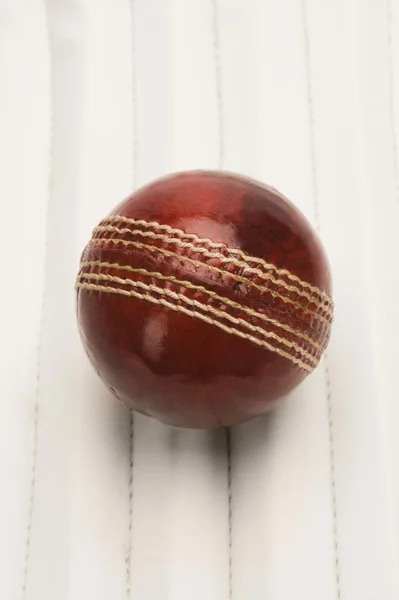 Cricket ball on a cricket pad — Stock Photo, Image