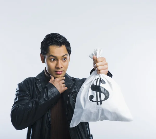 Hombre sosteniendo una bolsa de dinero — Foto de Stock