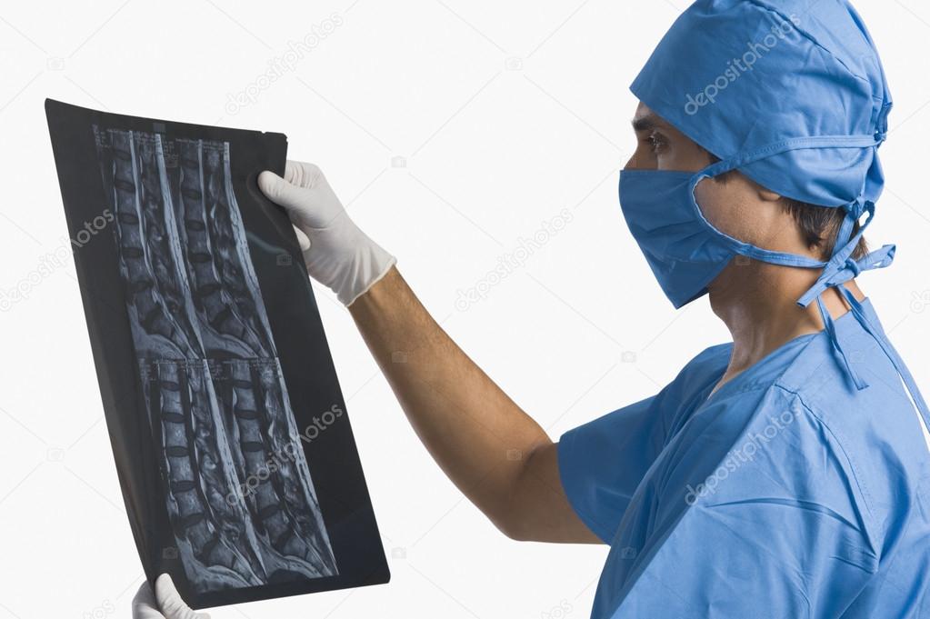 Surgeon examining an x-ray report
