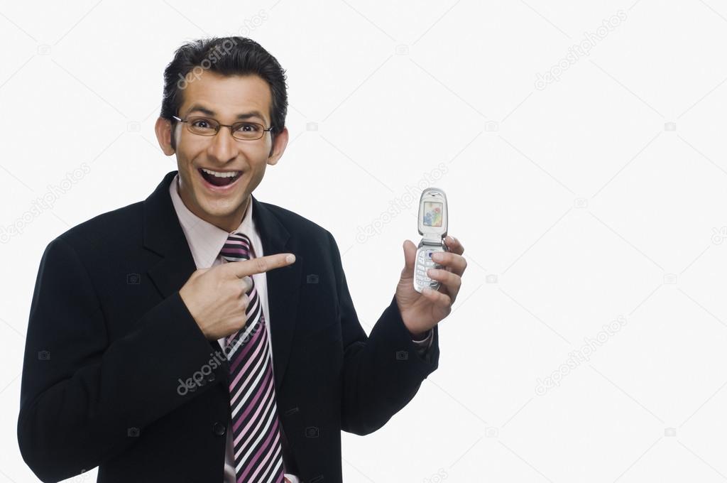 Businessman pointing at a mobile phone