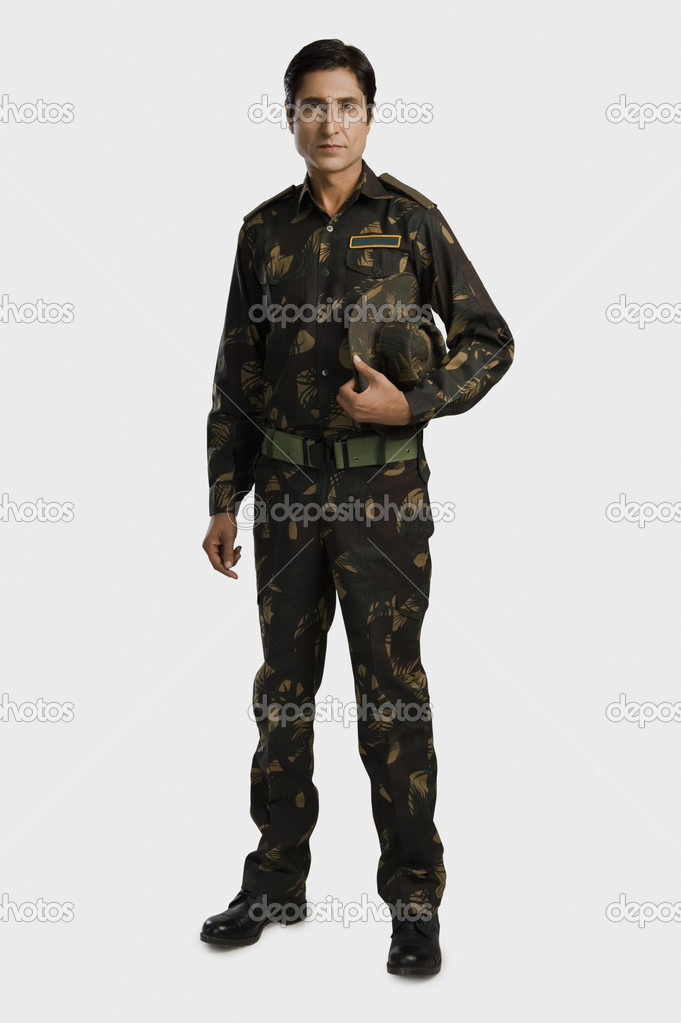 Army soldier holding a cap
