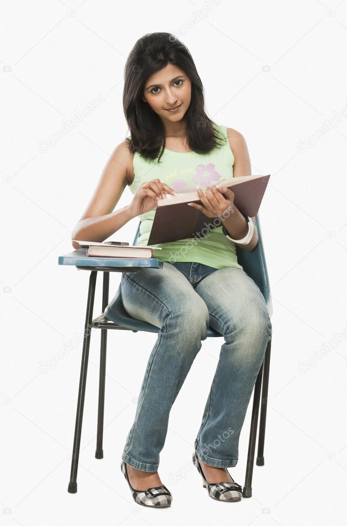Student reading a book in a classroom