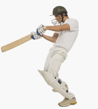 Cricket batsman playing a square cut shot clipart