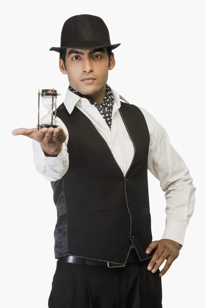 Businessman showing an hourglass — Stock Photo, Image