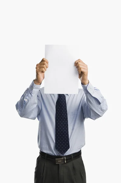 Businessman showing a sheet of blank paper — Stock Photo, Image