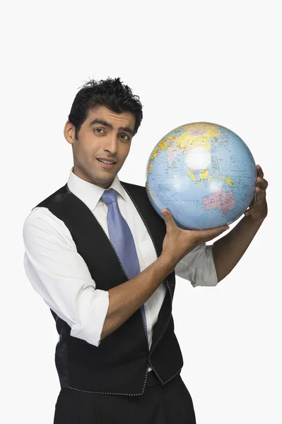 Businessman showing a globe — Stock Photo, Image