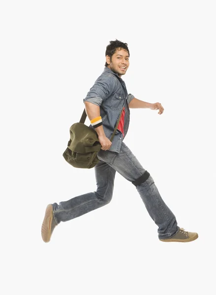 Studente che corre con una borsa a tracolla — Foto Stock