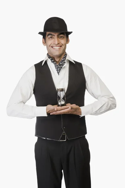 Businessman holding an hourglass — Stock Photo, Image