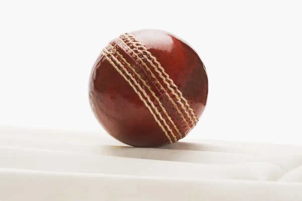 Cricket ball on a cricket pad — Stock Photo, Image