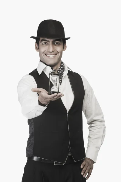 Businessman holding an hourglass — Stock Photo, Image