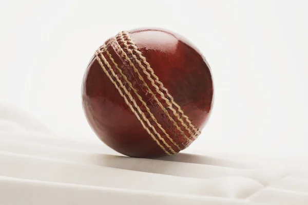 Cricket ball on a cricket pad — Stock Photo, Image