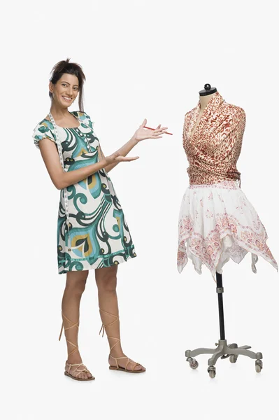 Fashion designer showing a dress — Stock Photo, Image