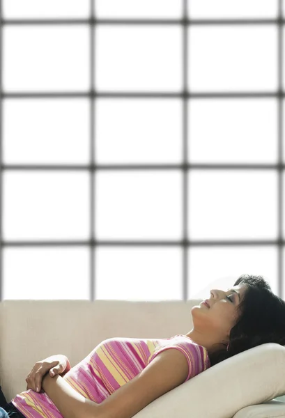 Woman sleeping on a couch — Stock Photo, Image