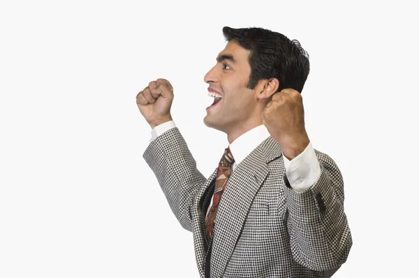 Businessman cheering and clenching fist — Stock Photo, Image
