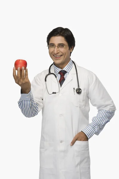 Doctor holding an apple — Stock Photo, Image