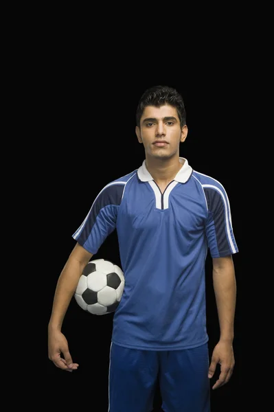 Fußballer hält einen Fußballball in der Hand — Stockfoto